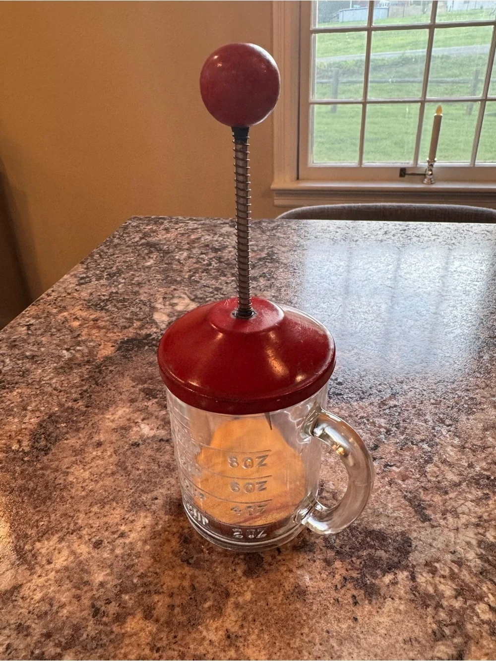 Vintage Hazel Atlas glass kitchen chopper with red lid and ball handle